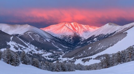 Majestic Sunrise Over Snow-Capped Mountain Range in Winter Wonderland