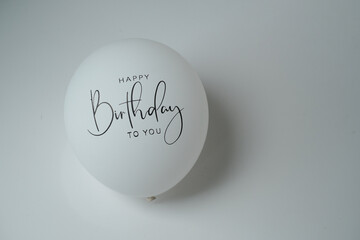 Balloons with Happy Birthday written on them on a white background