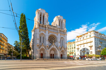 The front facade, rose window and towers of the Notre Dame cathedral in the center of Nice, France.