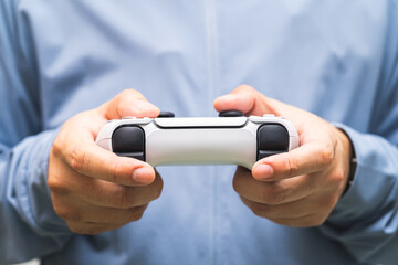 Fototapeta premium Man holding Game controller. Person holding the game controller.