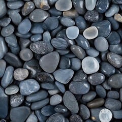 Pile of black pebble stones on the beach, background