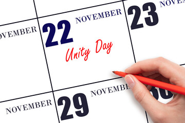 November 22. Hand writing text Unity Day on calendar date. Save the date.