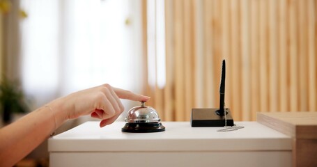 Hand, person and press bell at hotel reception as guest for help, customer service and hospitality....