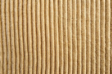 beige corduroy fabric background with a slightly worn macro close-up