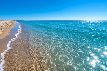 Obraz premium Background of a tranquil beach with clear blue water and gentle waves hitting the shore, perfect for relaxation scenes