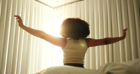 Stretching, wake up and morning with woman in bedroom of apartment for health, relaxing and...