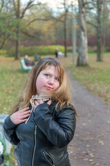 girl in a black jacket in an autumn park