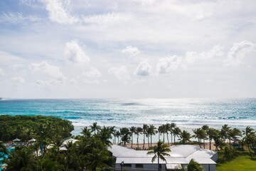 Fototapeta premium Panoramic View of a Tropical Paradise with Turquoise Waters and Palm Trees, Guam