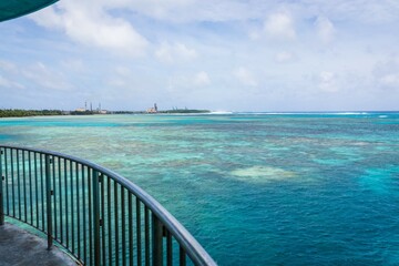 Pristine Turquoise Waters and Lush Green Island Under a Cloudy Sky, Guam