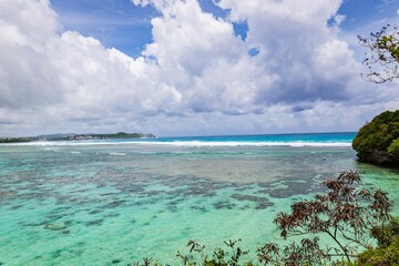 Scenic Coastal View with Clear Turquoise Waters and Cloudy Sky, Guam