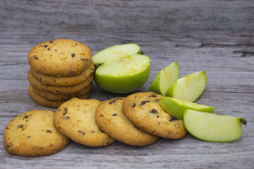 Stack of chocolate chip cookies with fresh green apple slices
