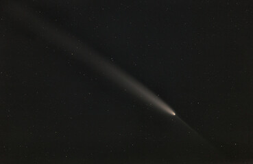 Real photo of comet C/2023 A3 (Tsuchinshan-ATLAS). Dark background. Soft focus.