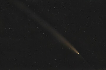 Real photo of comet C/2023 A3 (Tsuchinshan-ATLAS). Dark background. Soft focus. © Sergei