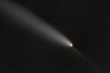 Real photo of comet C/2023 A3 (Tsuchinshan-ATLAS). Dark background. Soft focus.