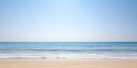 Serene coastal view of calm ocean waves gently lapping on sandy beach under clear blue sky
