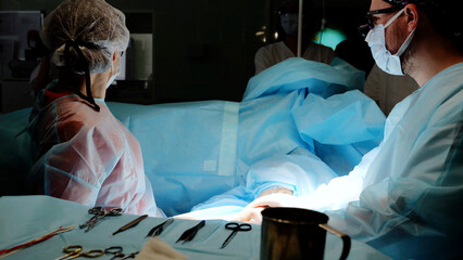 Skilled surgical team using advanced technology to perform precise surgery in a hospital operating room, highlighting teamwork and dedication for successful recovery
