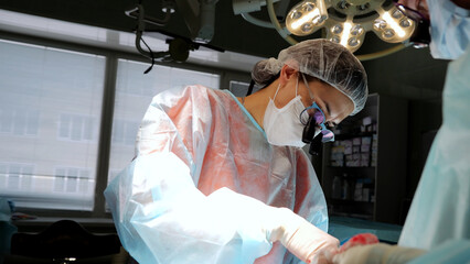Cutting-edge hospital surgeons perform delicate procedure surgical innovation patient survival. Group of medical professionals conducts intricate surgery importance of teamwork advanced techniques.