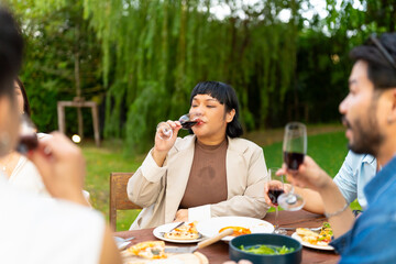 Group of Happy Asian millennial generation people friends enjoy and fun celebration reunion meeting outdoor dinner party with food and drink together in the garden at restaurant on holiday vacation.
