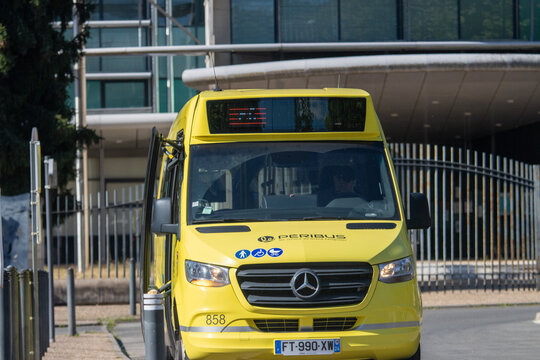 France, 16 August 2024 : Yellow minibus with open door parked in urban environment