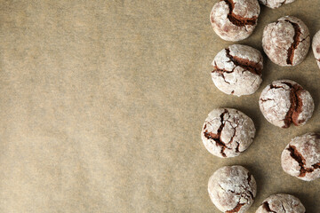 Appetizing crinkle cookies, on parchment, on a dark background.