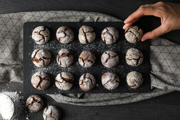 Delicious grinkle cookies on a black, stone board.