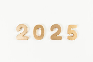 2025 Happy New Year. Top view of gold numbers on white background. Copy space, flat lay.