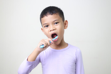 child Asia kid boy brushing teeth isolated on white backgroud.