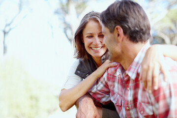 Obraz premium Hug, laughing and happy couple in nature for hiking, outdoor adventure or travel journey in woods. Love, joke or people with smile in forest for holiday vacation or trekking to explore together
