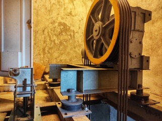 Specialist fixing or adjusting lift mechanism in elevator shaft. Regular repair, service and maintenance of elevators © Erdi
