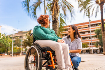 Woman with disability and friend in a city square