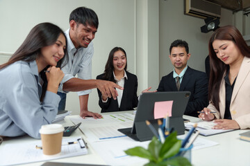 Financial analyst analyzes business finance reports on laptop and graph documents during corporate meeting discussions showing successful teamwork, business meeting ideas, marketing.