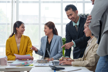 Teamwork process Business team of men and women use calculators to calculate business statistics, profits, cost analysis. Growth rate graph document Data chart on the desk in a collaborative office.