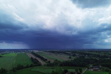 Obraz premium Dark storm approaching rural landscape with green fields