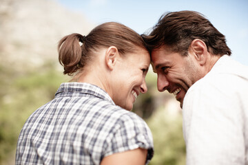 Fototapeta premium Couple, forehead touch and outdoor vacation on mountain, love and bonding adventure in Costa Rica. Happy people, sustainable honeymoon and together on holiday, profile and weekend trip for connection