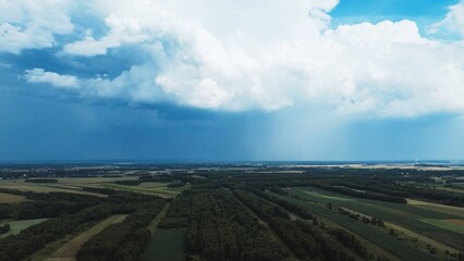Expansive fields beneath looming storm clouds
