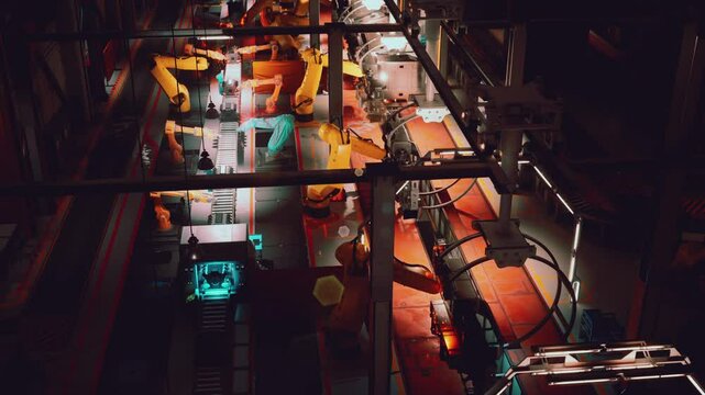 The conveyor system in a modern factory features robotic arms efficiently transporting materials, showcasing advanced automation technology in action during daytime operations.
