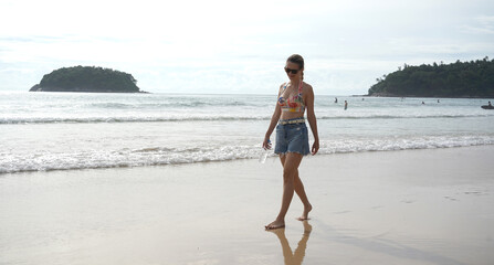 A young woman enjoying a beautiful day at the beach 