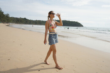 A young woman enjoying a beautiful day at the beach 