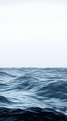 Fototapeta premium A panoramic view of the ocean with gentle waves and a clear blue sky.