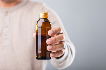 A man holds a bottle energy drink, prompting the question of its health impact-whether it boosts...