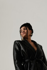 Powerful African American young woman staying over white background. Vertical.