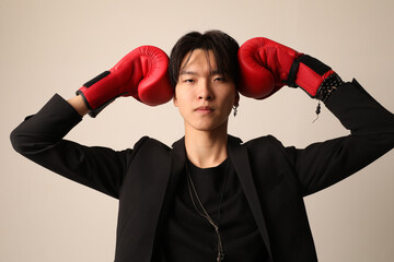Self-confident young Asian man with red boxer gloves. Mock-up.