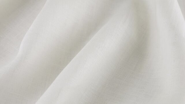 Soft folds of the white linen fabric rotates on the showcase. Top view of textile background. Theme design, fashion, tailoring of clothes.