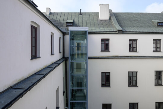 Modern outdoor elevator in old historic hotel building