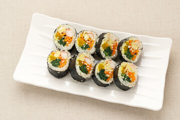 Korean Rolled Gimbap, made of rice, cucumber, tuna, carrot, sausage, crab stick and wrapped with seaweed laver. 
