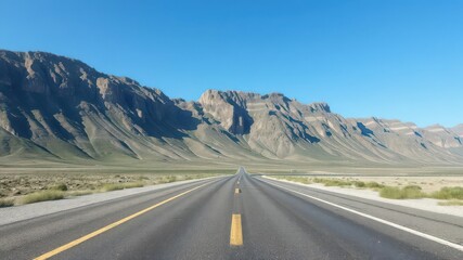 Fototapeta premium Empty highway asphalt road cutting through breathtaking mountain landscape under a clear blue sky, empty, panoramic