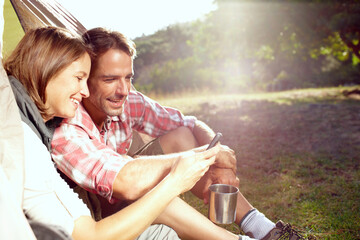 Couple, nature and camping with smartphone by tent for social media meme, funny video and...