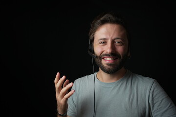 Friendly Caucasian Customer Service Agent is smiling. Black background. 