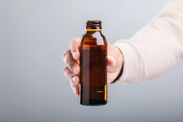 A man holds a bottle energy drink, prompting the question of its health impact-whether it boosts...