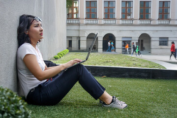 Introvert Asian woman student Working in Nature with Laptop Work in Green Space
